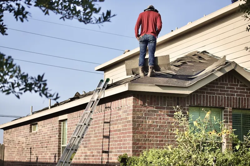 Professional roofer working on a residential roof in Lumberville